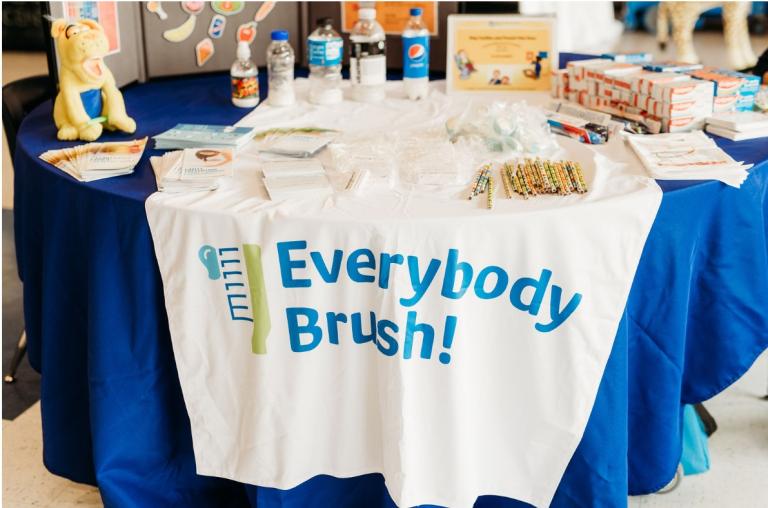 A table set-up for an Advantage Dental "Everybody Brush!" community care event.